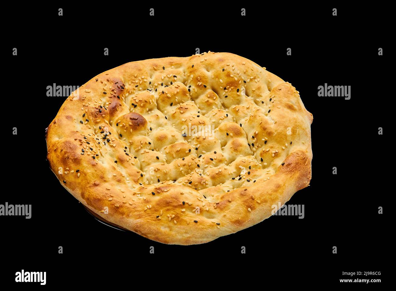Fried crusty flatbread with sesame seeds on a black isolated black background Stock Photo Alamy