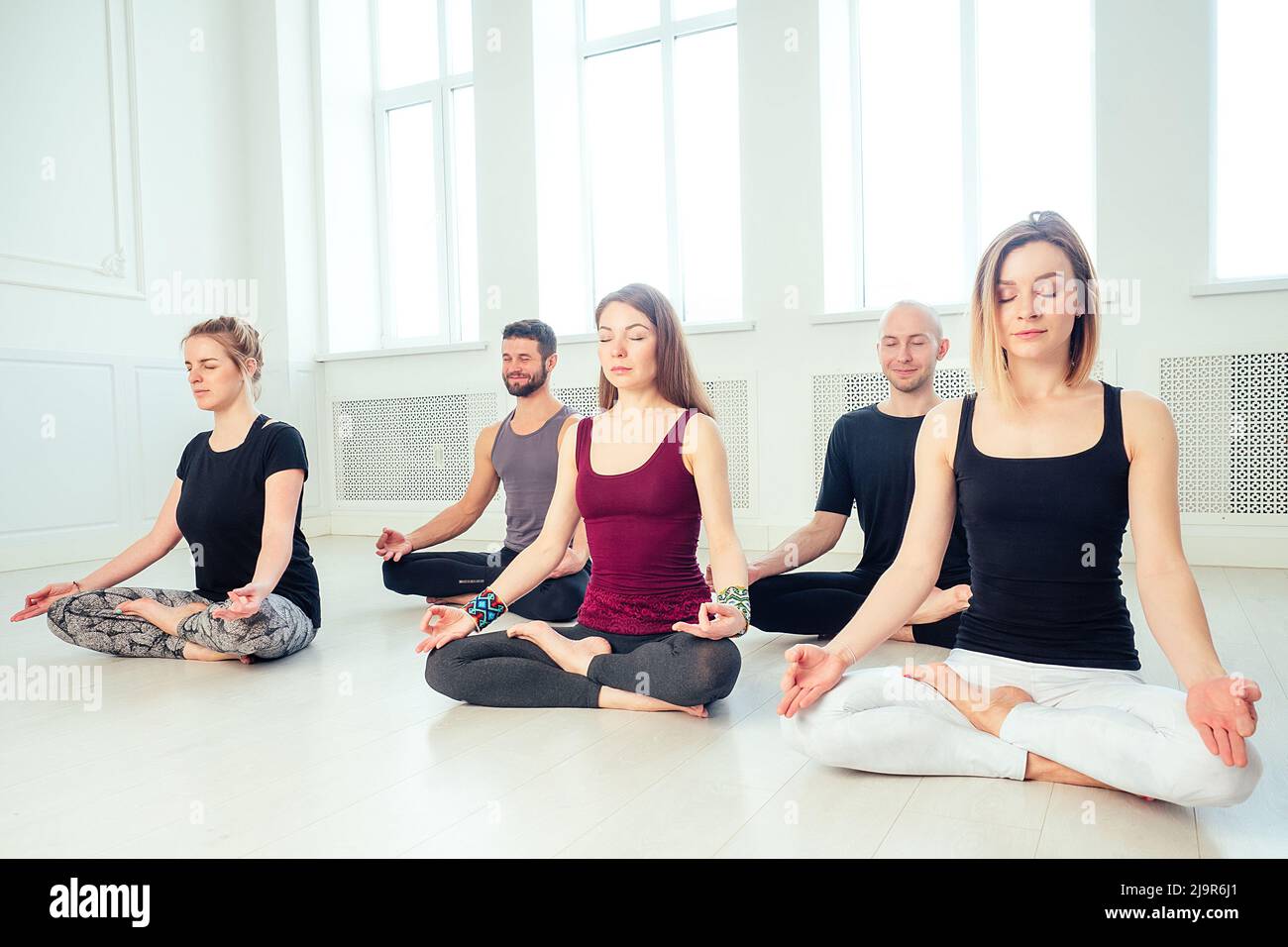 happy group of people of three women practicing yoga in the studio. groups  of meditation and stretching a yoga class. the concept of group meditation  and teamwork. women's health Photos