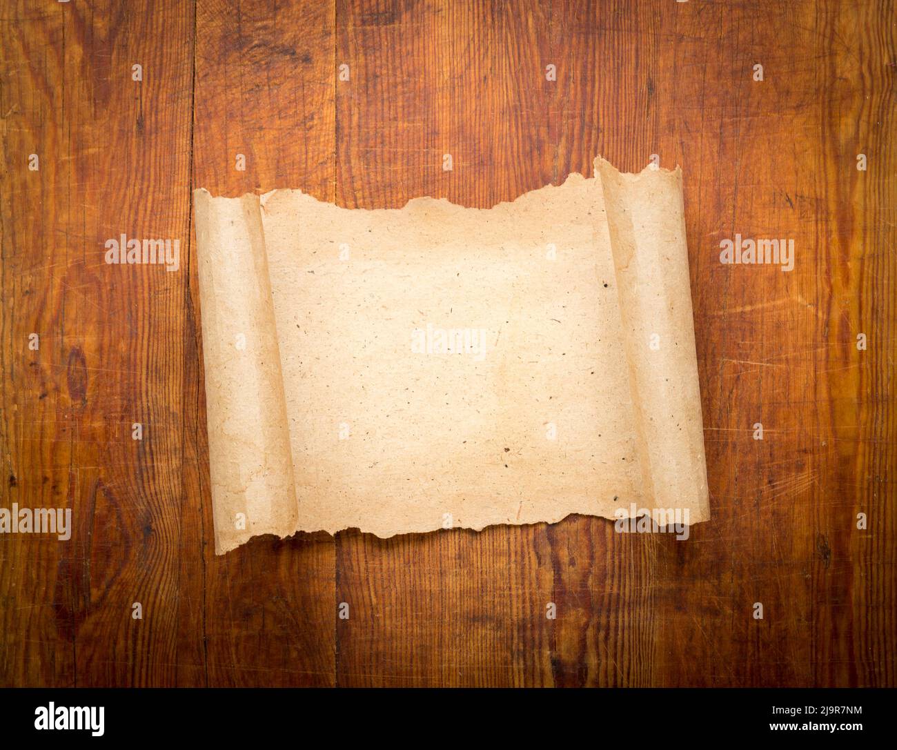 parchment scroll on wooden background. Stock Photo