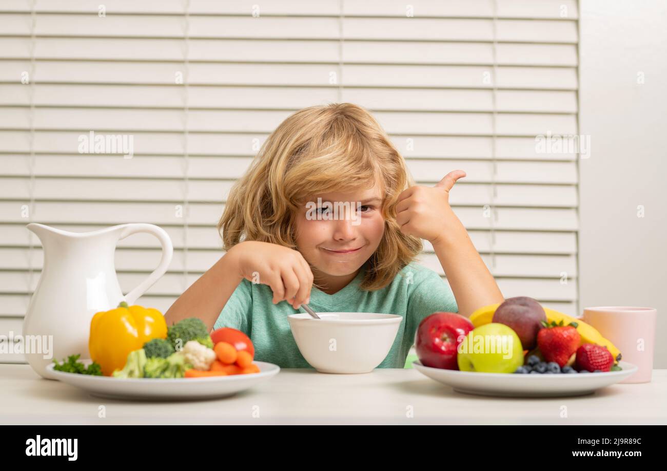 Little child boy having healthy breakfast. Kids nutrition and
