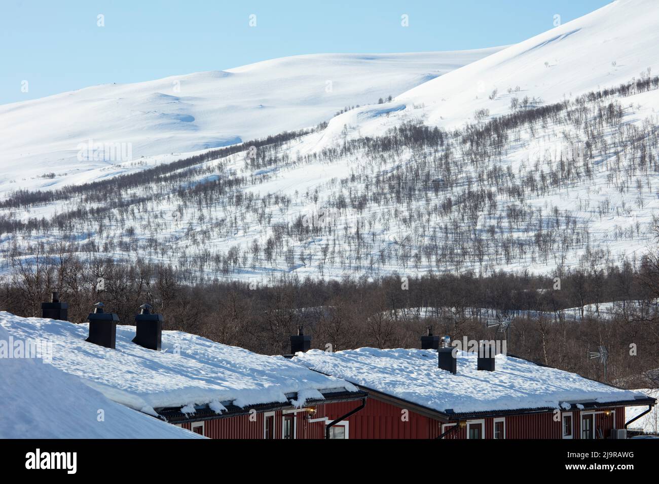 Scandinavian Mountains in March. Bright sunshine, thaw on the hillside