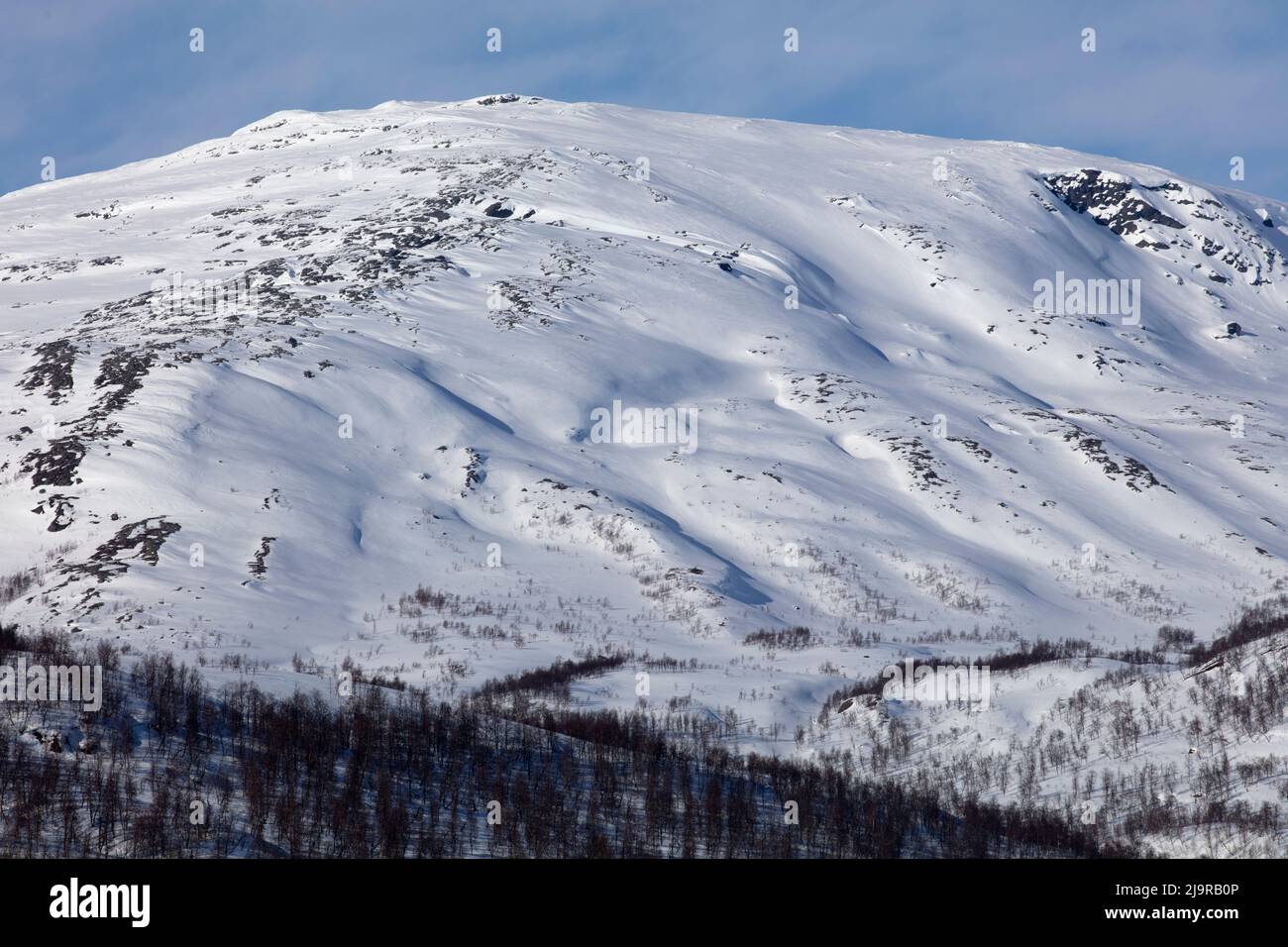 Scandinavian Mountains in March Bright sunshine thaw on the hillside Scandinavian Mountains in March Bright sunshine thaw on the hillside