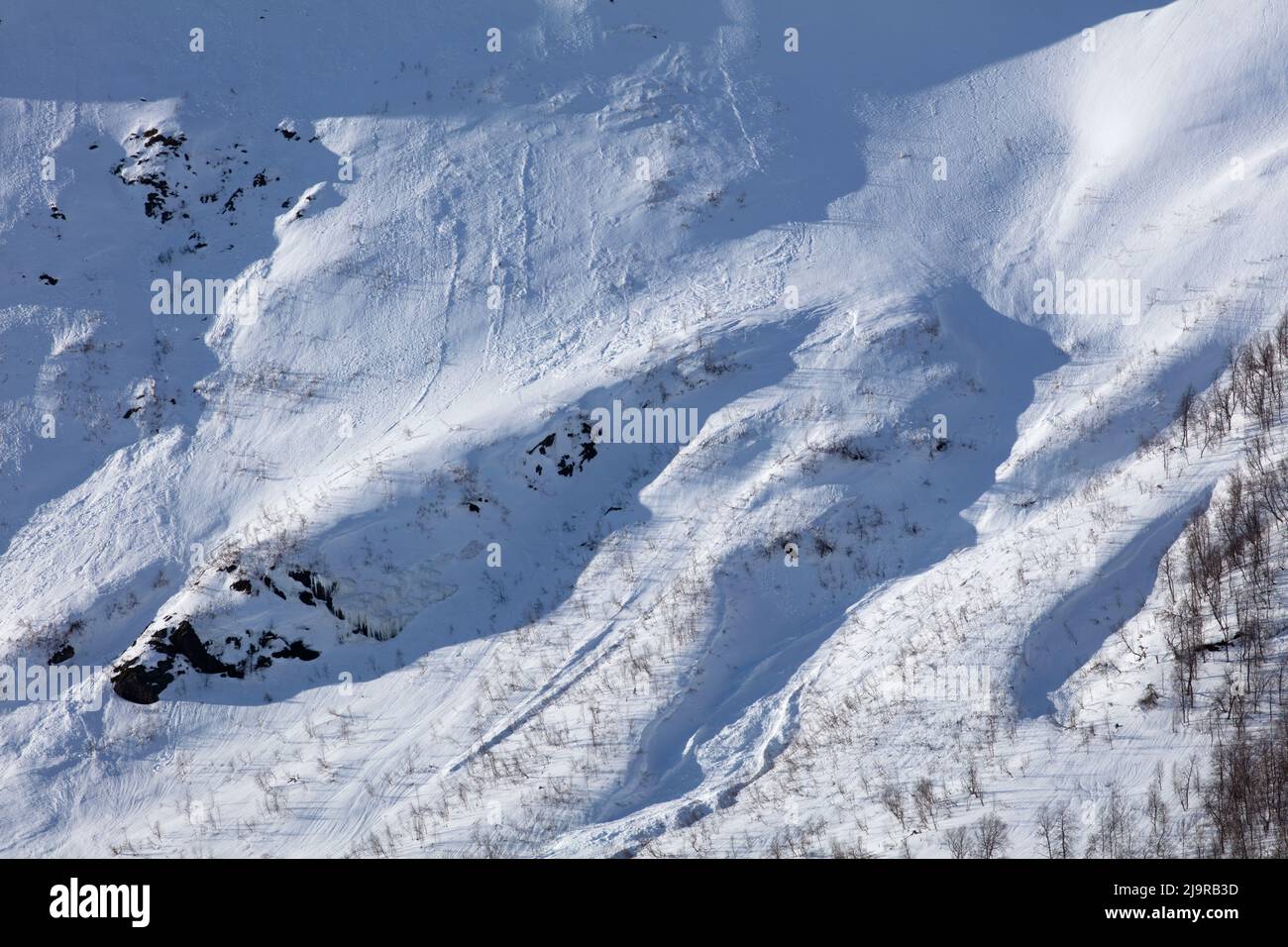 Scandinavian Mountains in March. Bright sunshine, thaw on the hillside