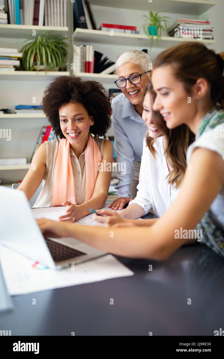 Group of happy business people working together on new project in