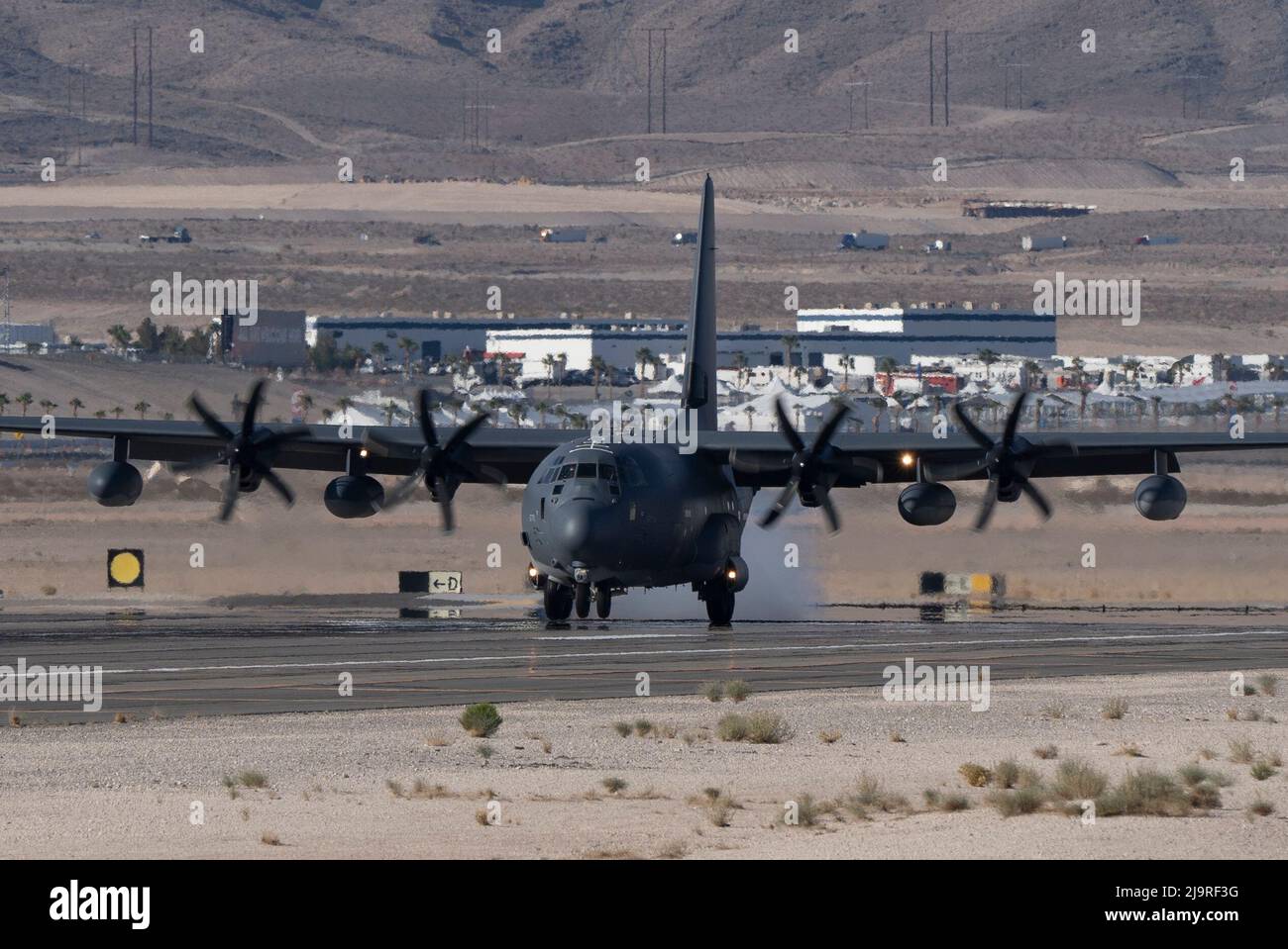 A C-130J lands after a Weapons School Integration (WSINT) training mission at Nellis AFB, Nevada, May 18, 2022.   The goal of the U.S. Air Force Weapons School is to train students to be tactical experts in their combat specialty while also learning the art of battlespace dominance. (U.S. Air Force photo by William R. Lewis) Stock Photo