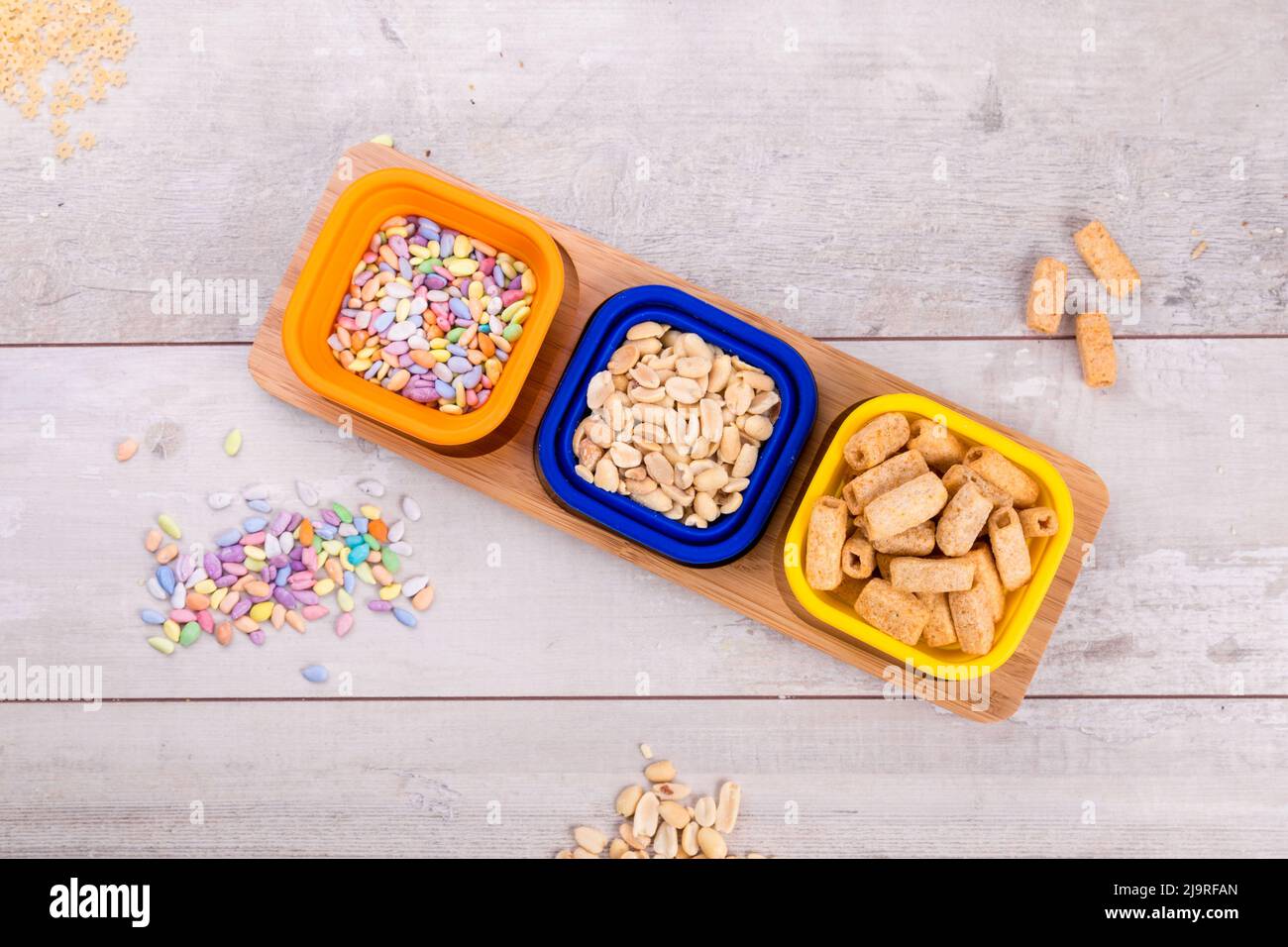 Mix nuts and chips on wooden table,. Stock Photo