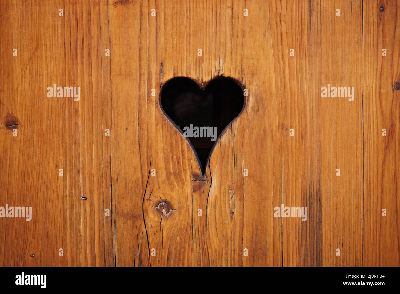 Heart shape in light brown wood plank. Alsace traditional decoration Stock Photo
