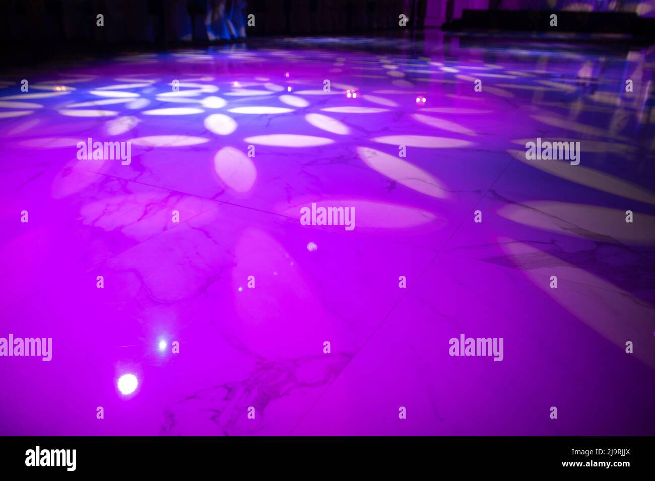 The marble dance floor is flooded with professional lighting equipment