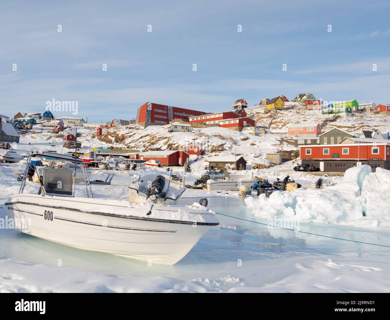 The frozen harbor of Uummannaq during winter in northern West Greenland beyond the Arctic Circle. Greenland, Danish territory Stock Photo