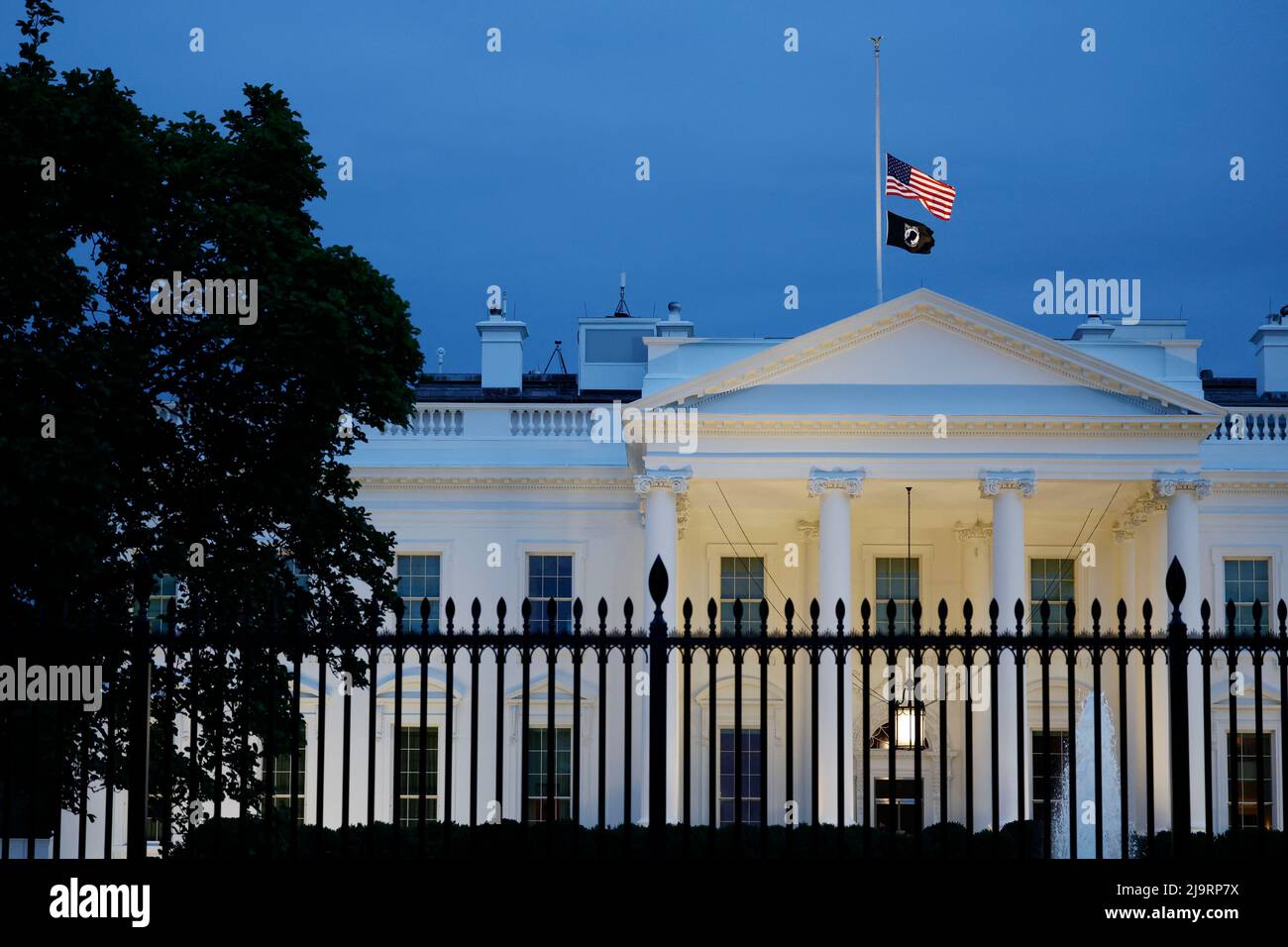 Washington, USA. 24th May, 2022. The U.S. flag flies at half-staff on top of the White House in Washington, DC, the United States, on May 24, 2022. At least 19 children and two adults were killed in a shooting at Robb Elementary School in the town of Uvalde, Texas, on Tuesday. Credit: Ting Shen/Xinhua/Alamy Live News Stock Photo