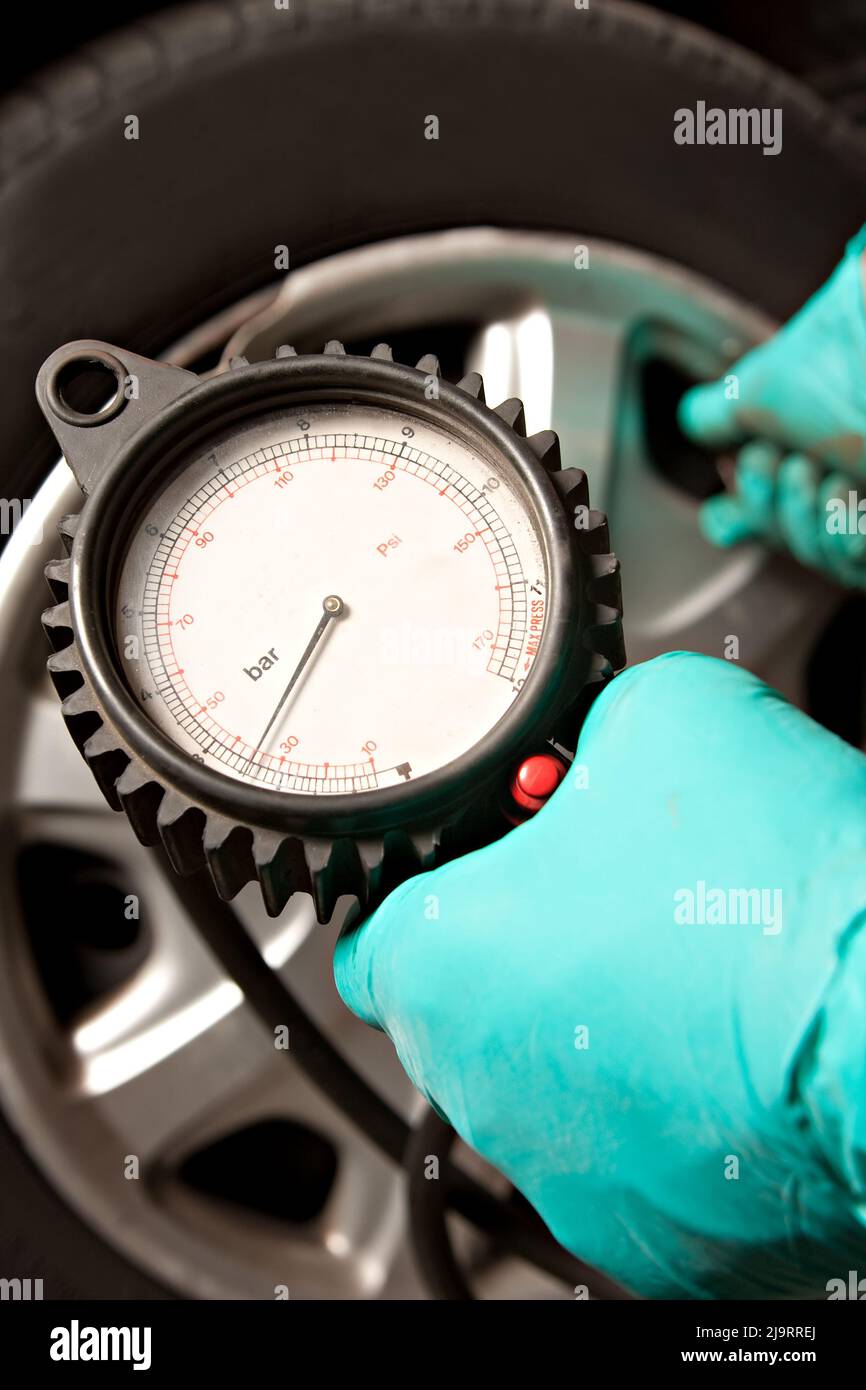 Car Tire Pressure Check in the Auto Service Garage. Checking and