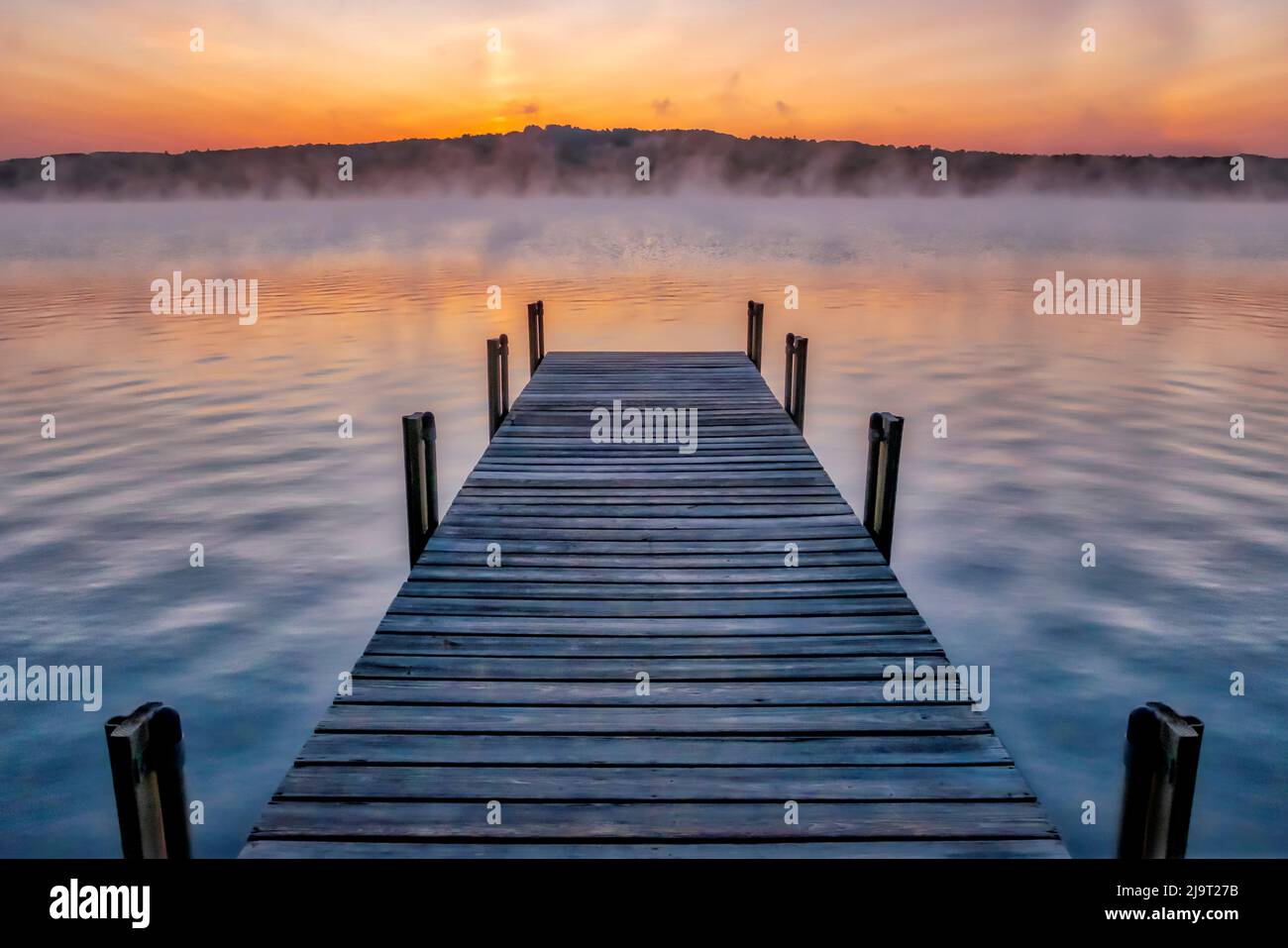 Dock on Long Lake at sunrise, Bridgton, Maine Stock Photo