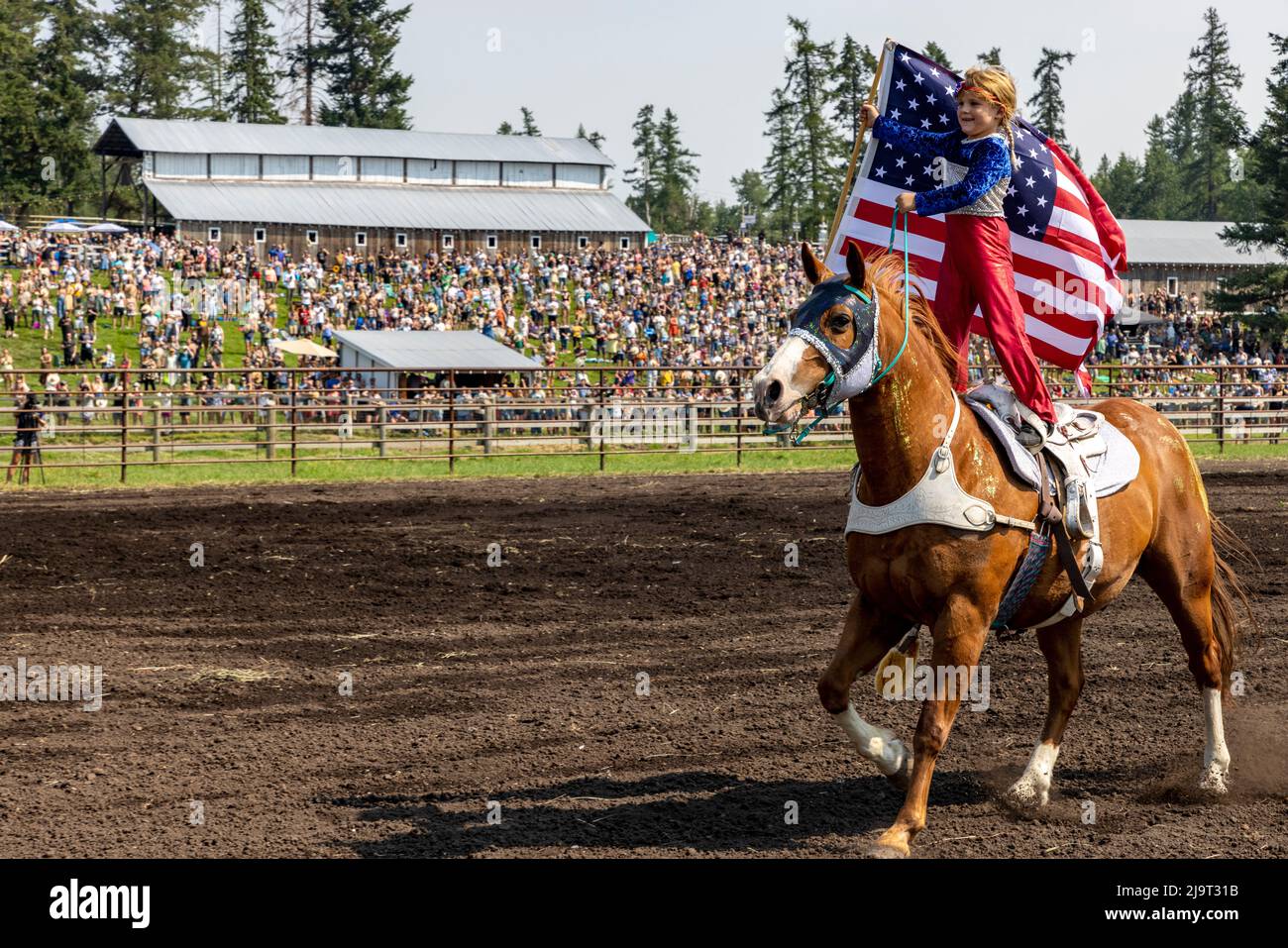 Young girl rides with American flag at Rodeo opening during the Under ...