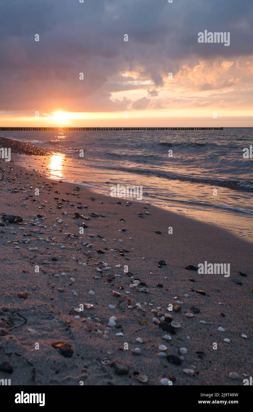 Sunset on the Baltic Sea. Sea, bean strong colors. Vacation on the beach. Romantic mood on the darss. Landscape photo. Stock Photo