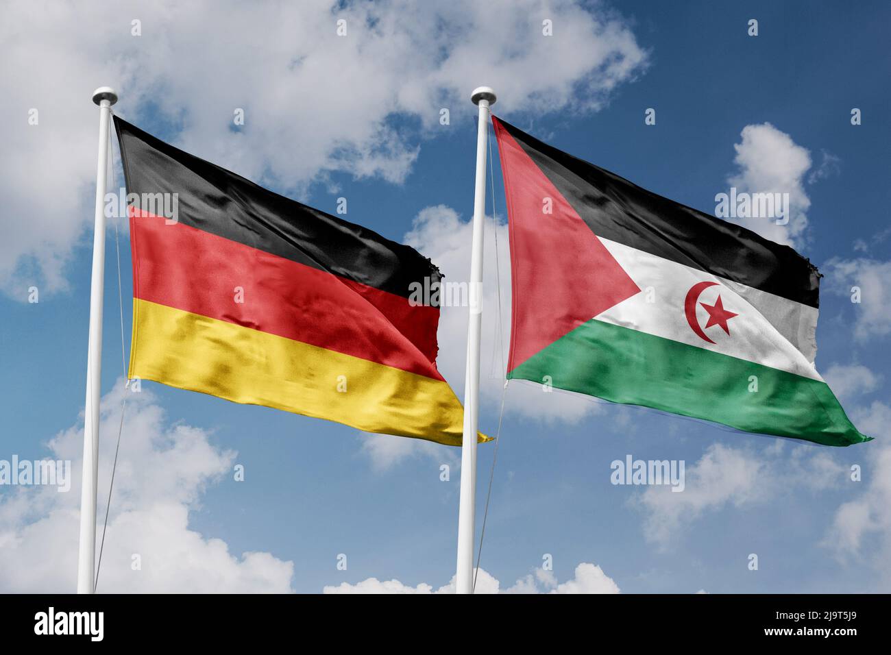 Germany and Sahrawi Arab Democratic Republic two flags on flagpoles and blue cloudy sky background Stock Photo