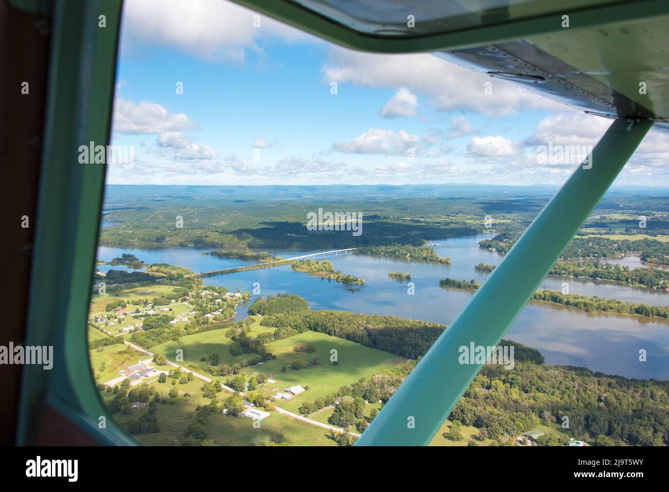 USA, Tennessee. Cloud shadows on river patterns. Airplane window framing scene. Highway 58 Decatur Bridge Stock Photo