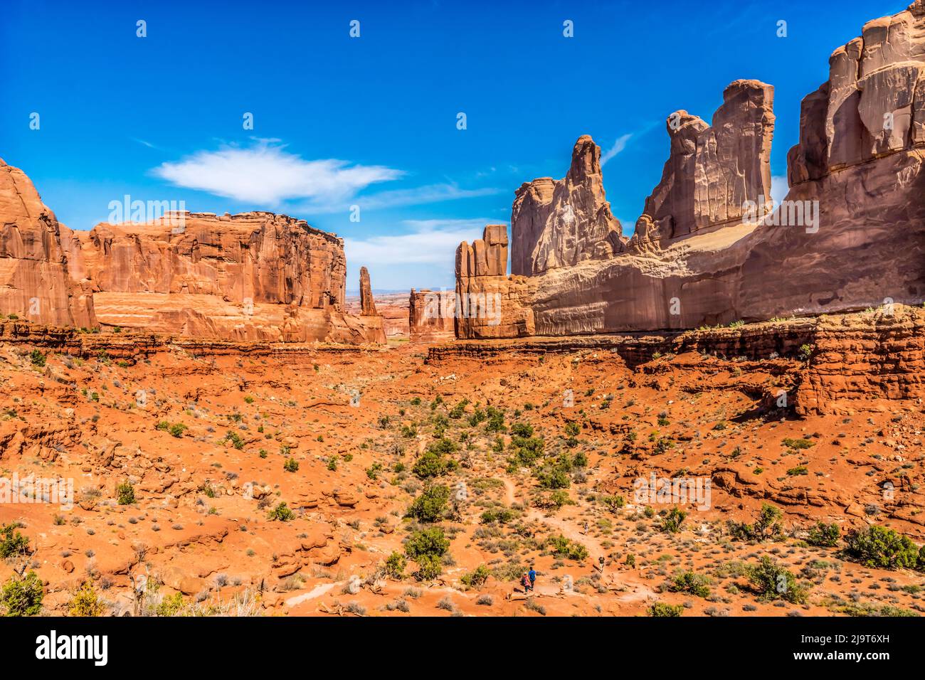 Hikers, Arches National Park, Moab, Utah, USA. Classic sandstone walls