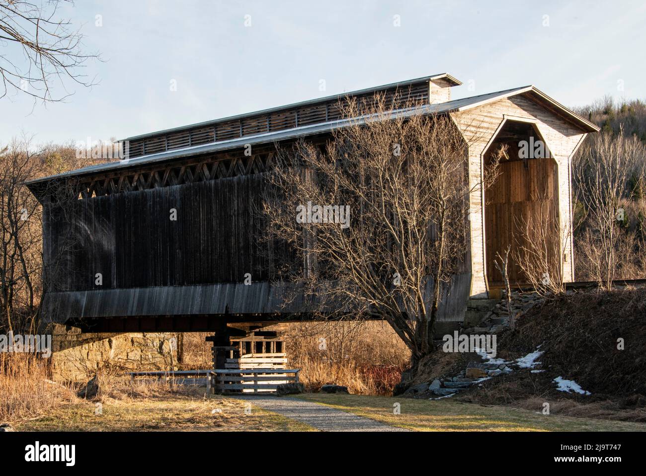 USA, Vermont, Wolcott on Rt. 15 between Morrisville and Joe's Pond, covered RR bridge over Lamoille River Stock Photo