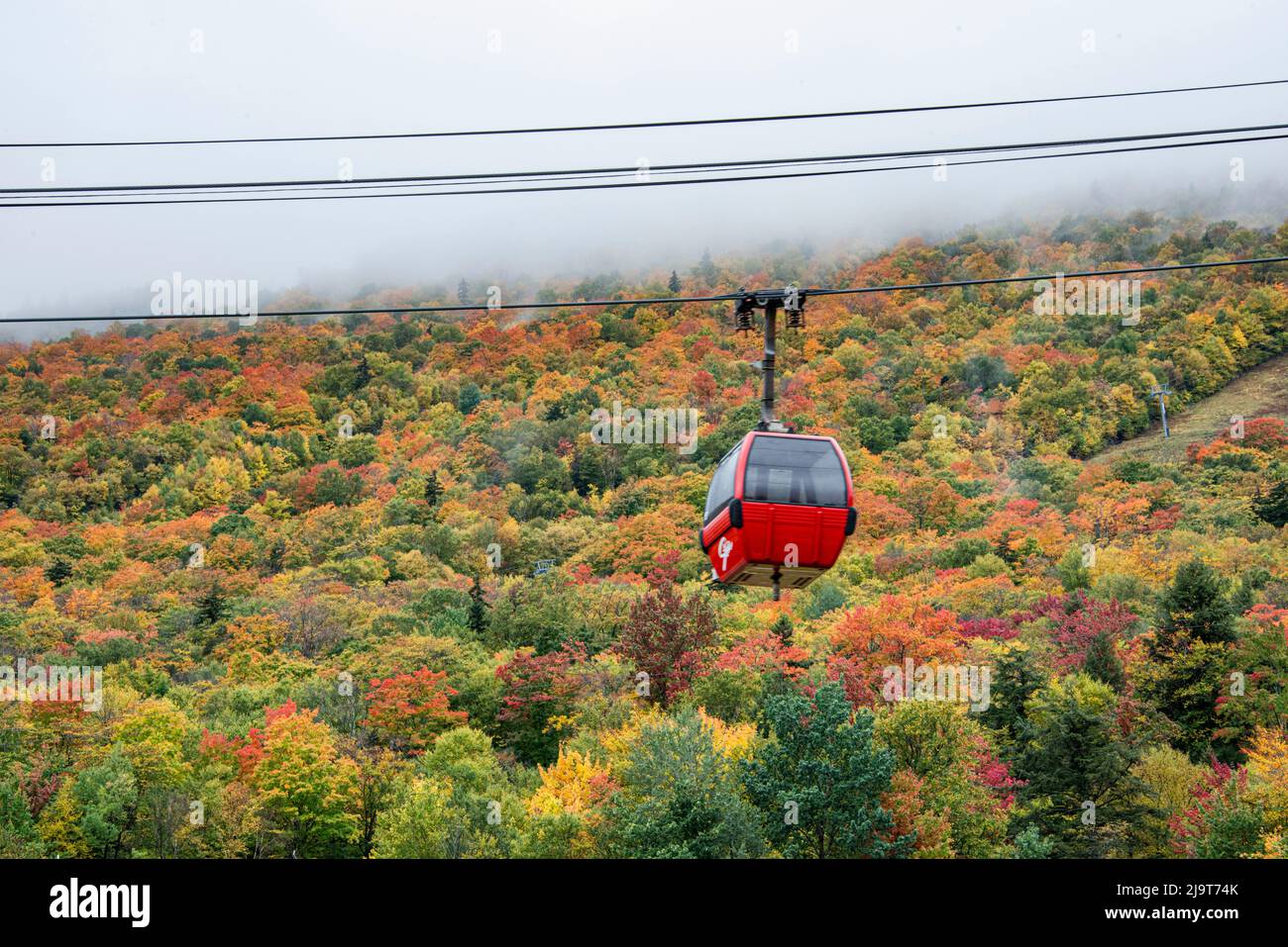 USA, Vermont, New England, Stowe Mt. Mansfield parking lot view with fog on mountains, Stowe