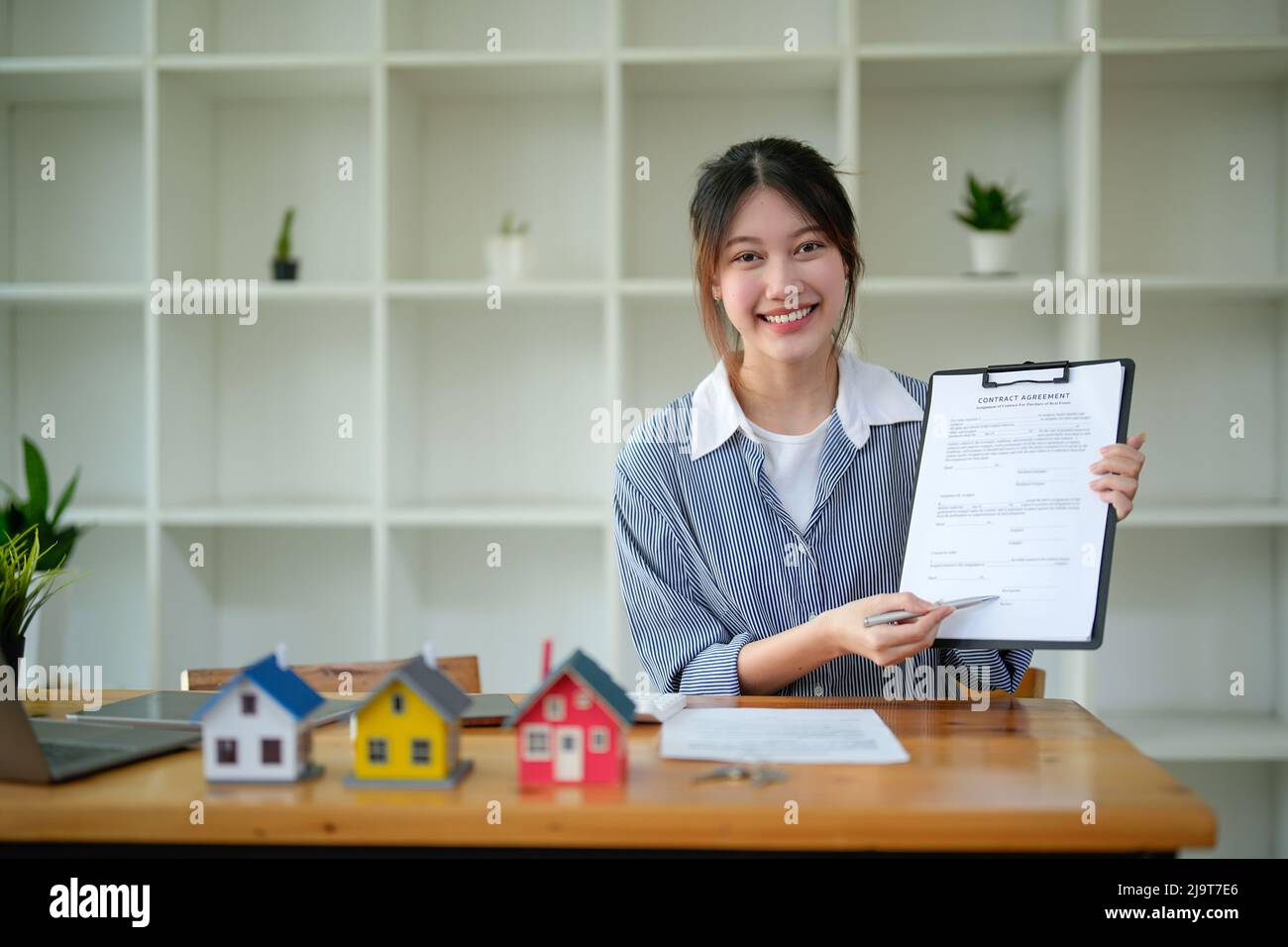 Portrait real estate agent adviser show contract agreement on workplace