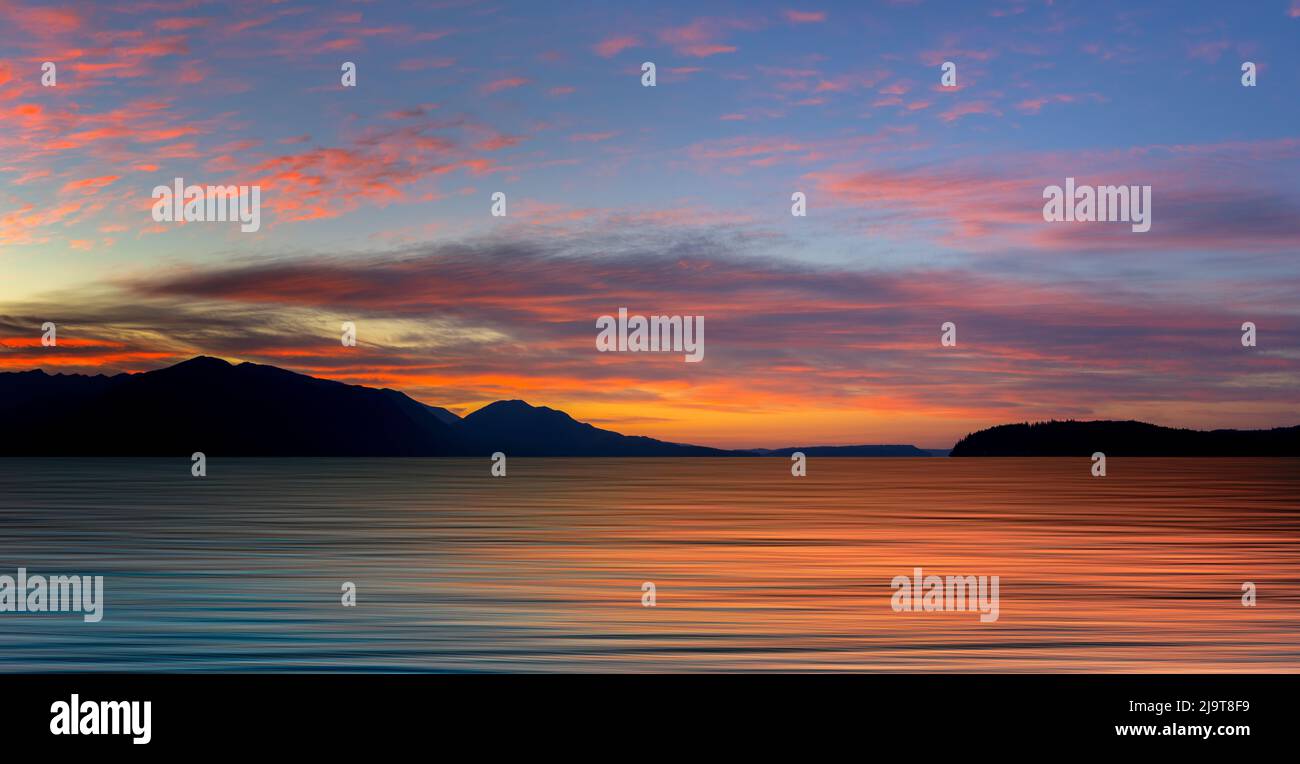 USA, Washington State, Seabeck. Composite panoramic sunset over Hood Canal. Stock Photo