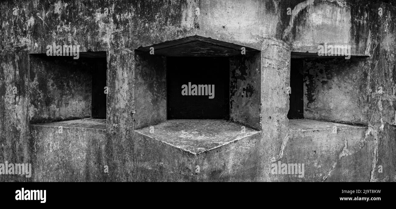 USA, Washington State, Fort Flagler State Park. Black and white detail of gun ports in wall. Stock Photo