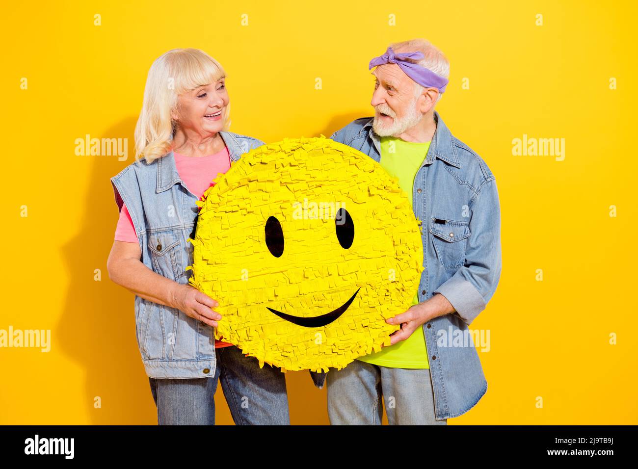 Photo Of Sweet Dreamy Husband Wife Wear Jeans Shirts Holding Smiley Isolated Yellow Color 