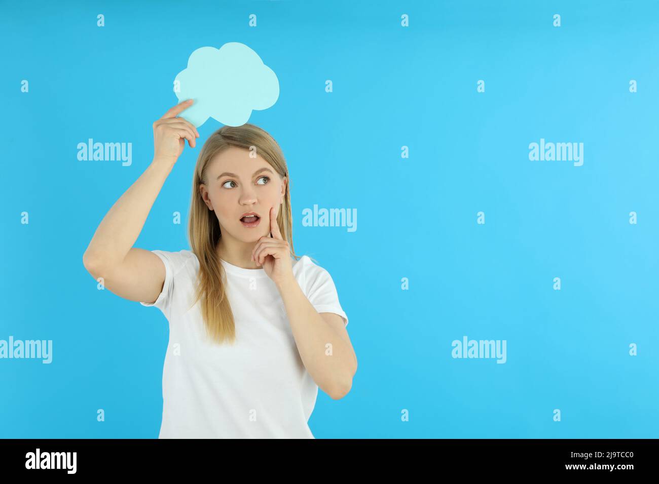 Young woman with speech bubble on blue background Stock Photo
