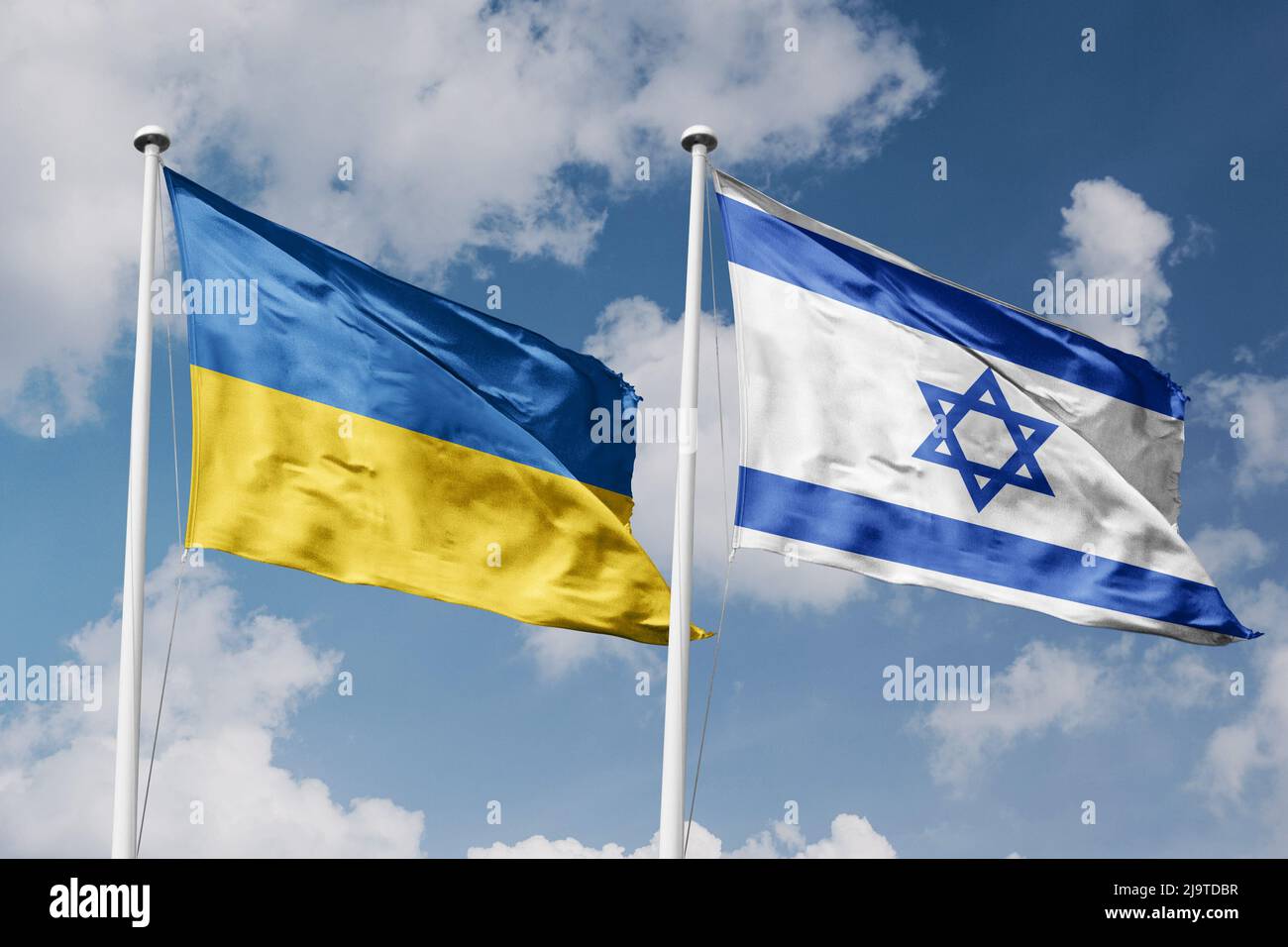 Ukraine and Israel two flags on flagpoles and blue cloudy sky background Stock Photo
