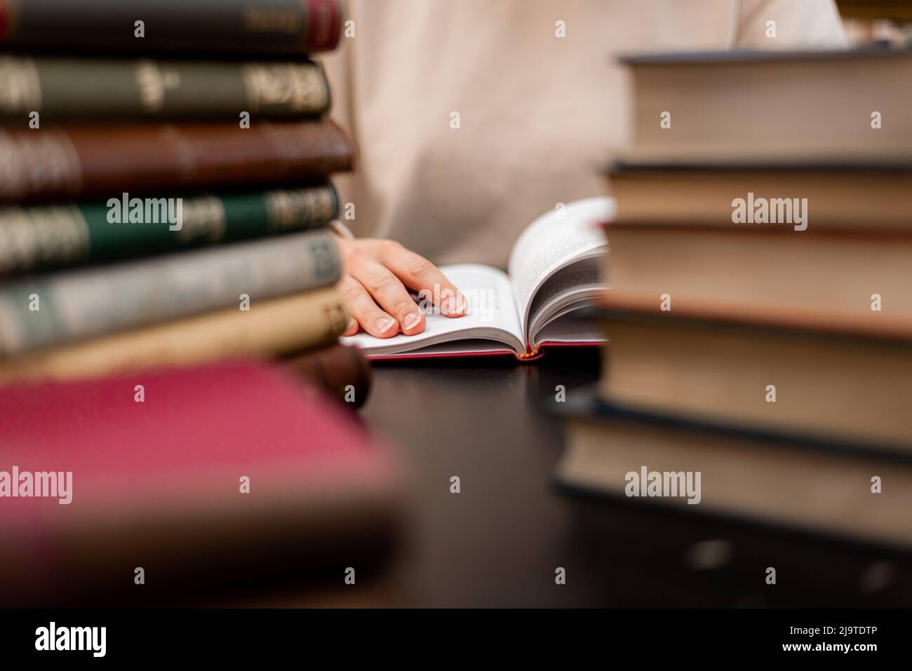 Details of a girl reading book in a library Stock Photo - Alamy