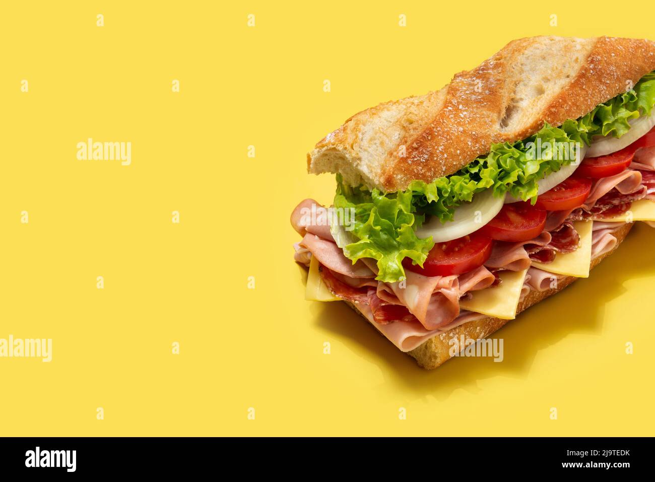 Submarine sandwich with ham, cheese, lettuce, tomatoes,onion