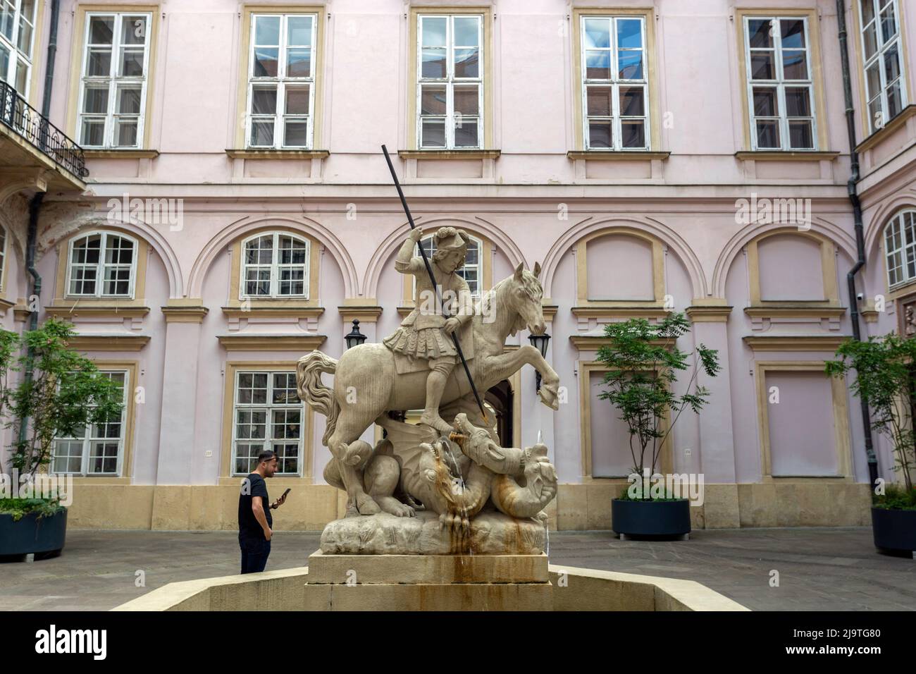 Bratislava, Slovakia - 05 21 2022: The courtyard of the Primate's Palace in Bratislava with the statue of Saint George in the foreground. Stock Photo