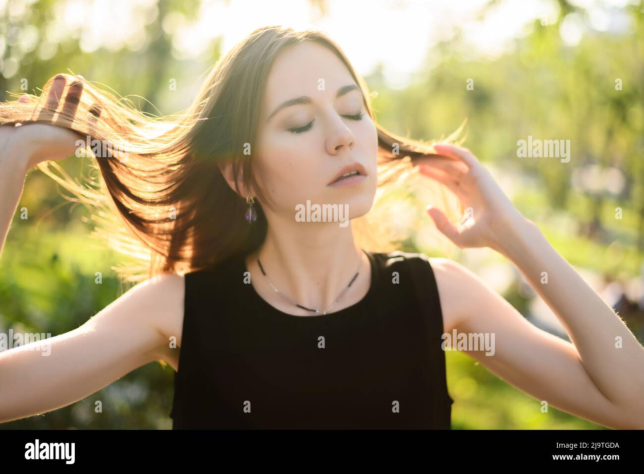 Portrait of beautiful young woman in the park Stock Photo - Alamy