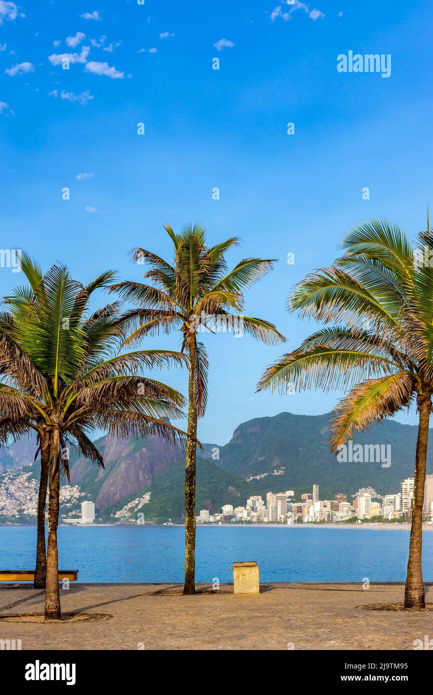 Ipanema beach in Rio de Janeiro during a summer morning with the hills and city buildings in the background Stock Photo