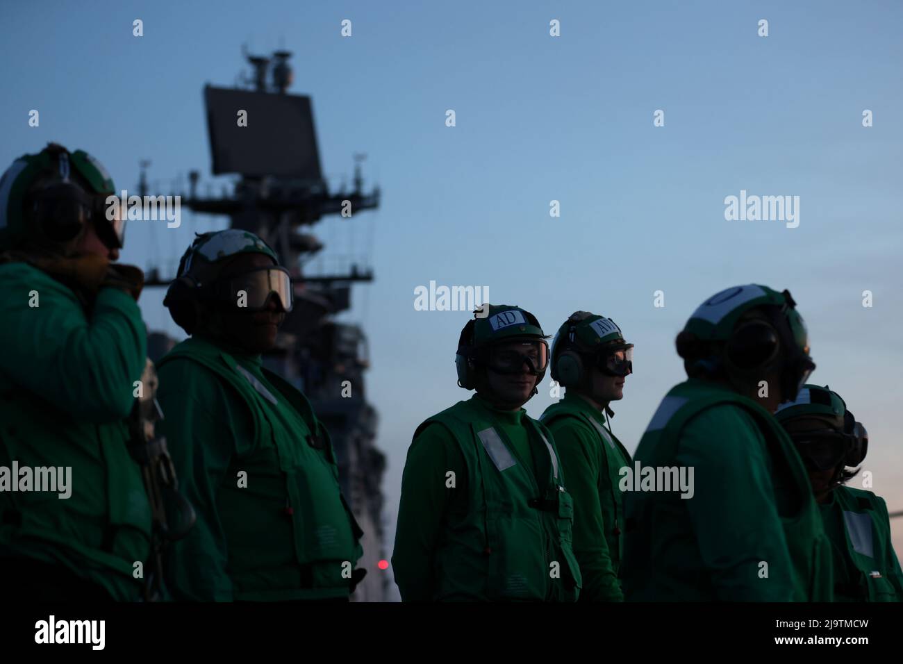 U.S. Navy Flight Deck Maintainers stand aboard the USS Bataan, a U.S. Navy Wasp-class amphibious assault ship, ahead of 'Fleet Week' 2022 in the North Atlantic Ocean off the coast of New York, U.S., May 24, 2022. Picture taken May 24, 2022. REUTERS/Andrew Kelly Stock Photo