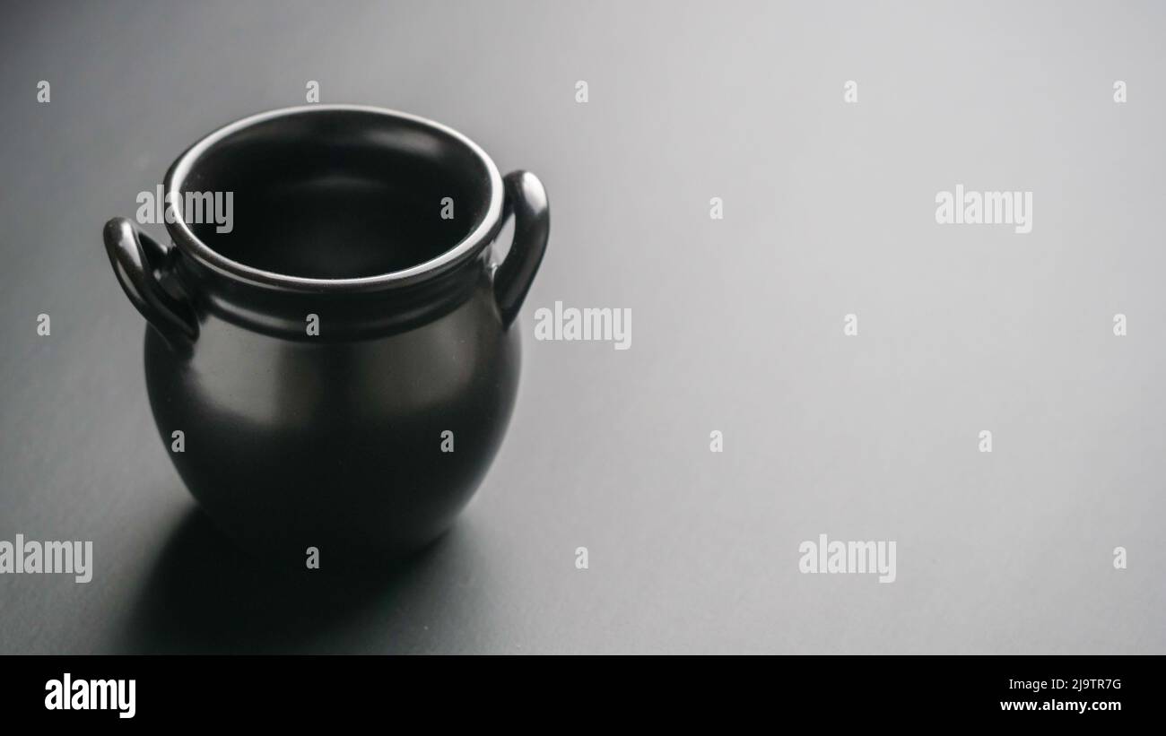 Black handmade ceramic empty jar on the table Stock Photo