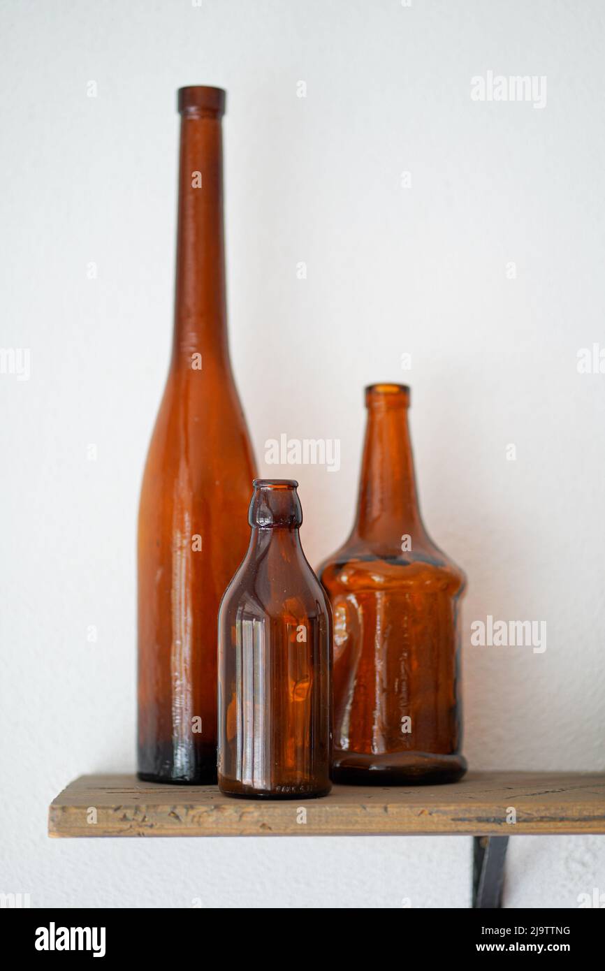 Empty old vintage wine glass bottles on the wooden shelf Stock Photo