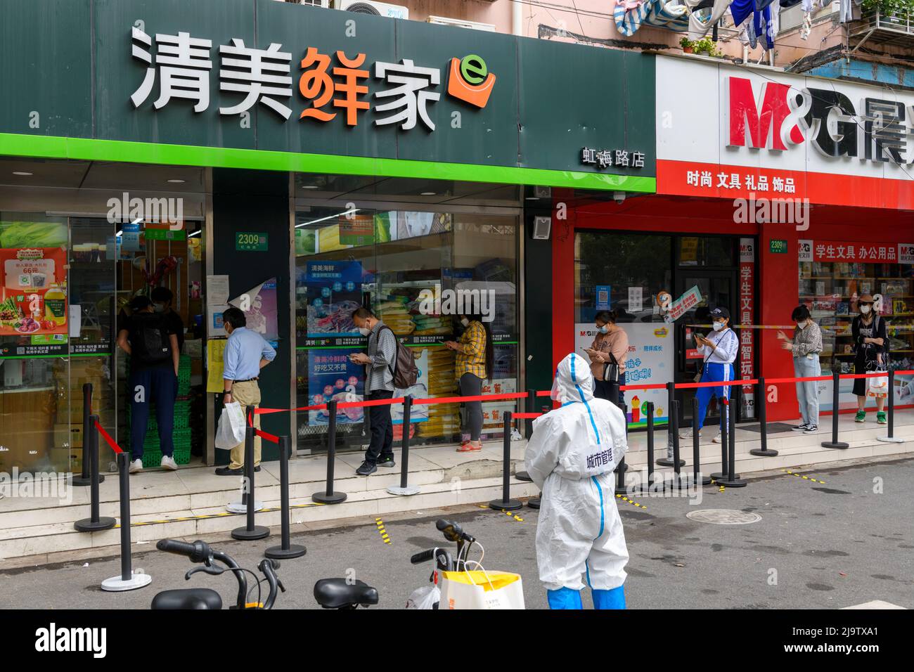 Shanghai residents line up at their neighborhood market to purchase food for the first time since the lockdown. Stock Photo