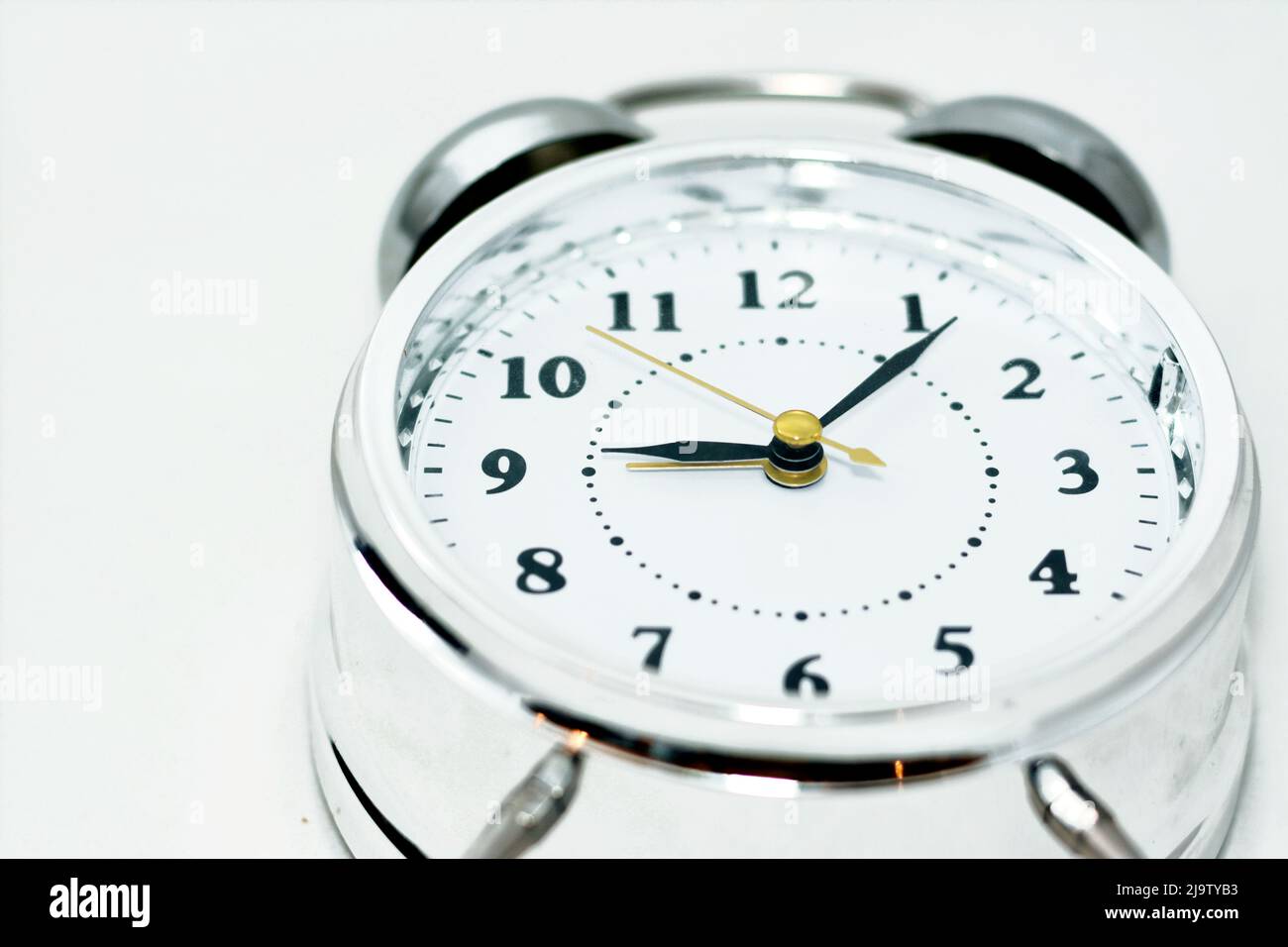 Sliver alarm clock isolated on white background, a vintage retro old