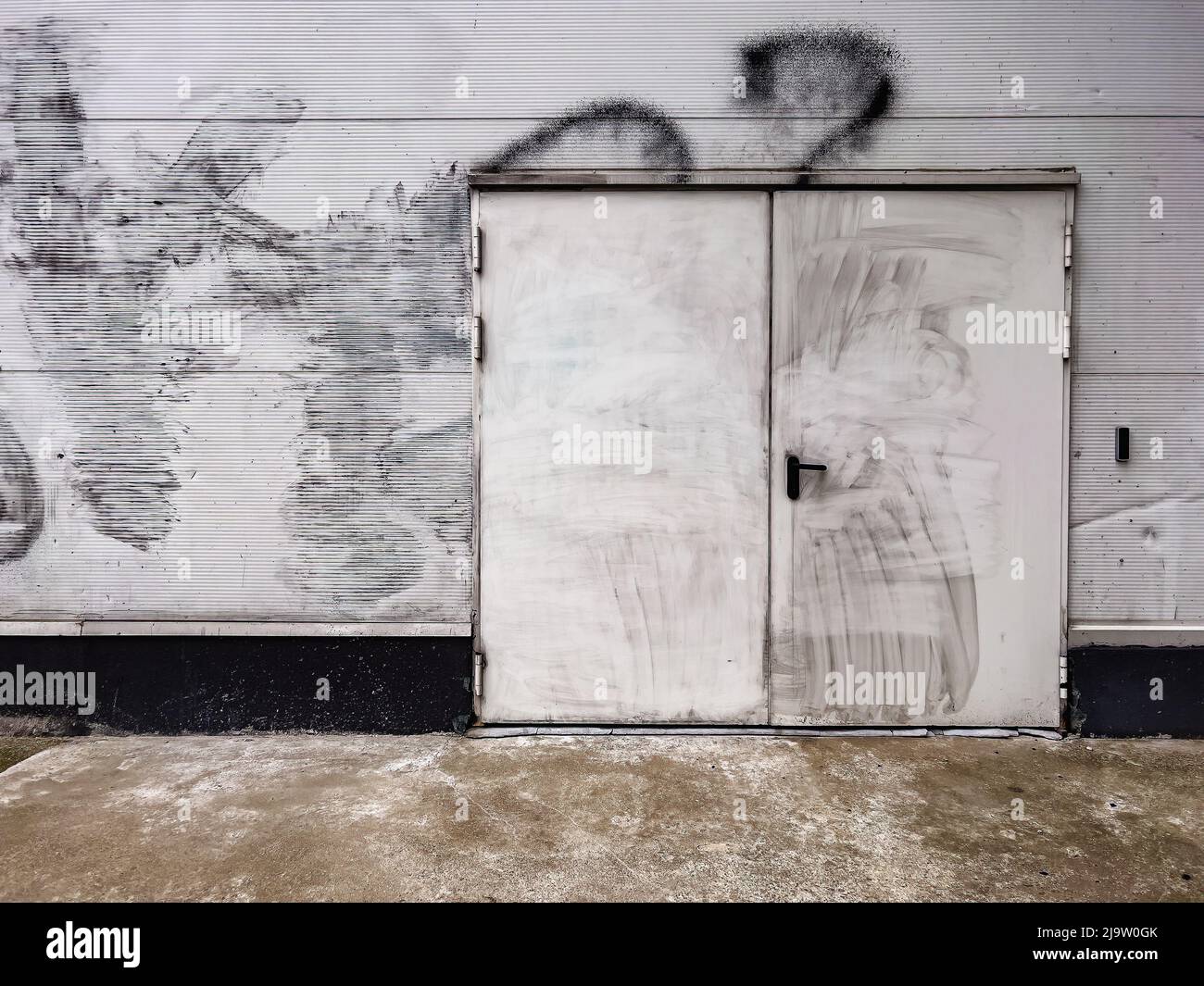 Dirty back door of an industrial building as grunge background Stock Photo