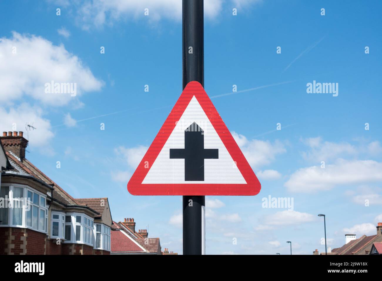 Crossroad warning sign on a lamppost in residential area in London Stock Photo