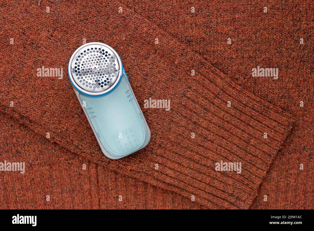Top view of lint remover on wool fabric Stock Photo Alamy