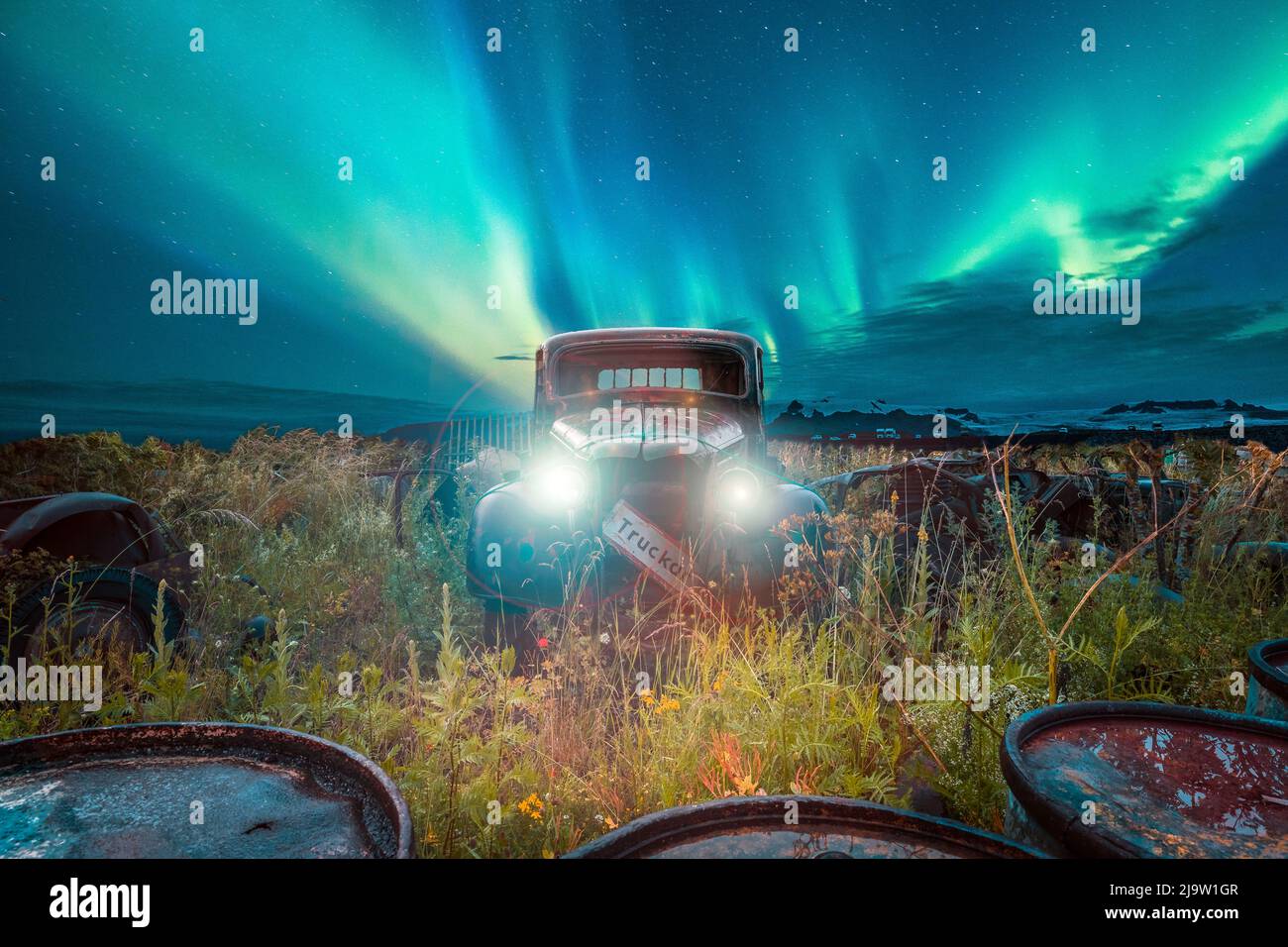 Composing of a car in Sweden and an aurora in Iceland Stock Photo