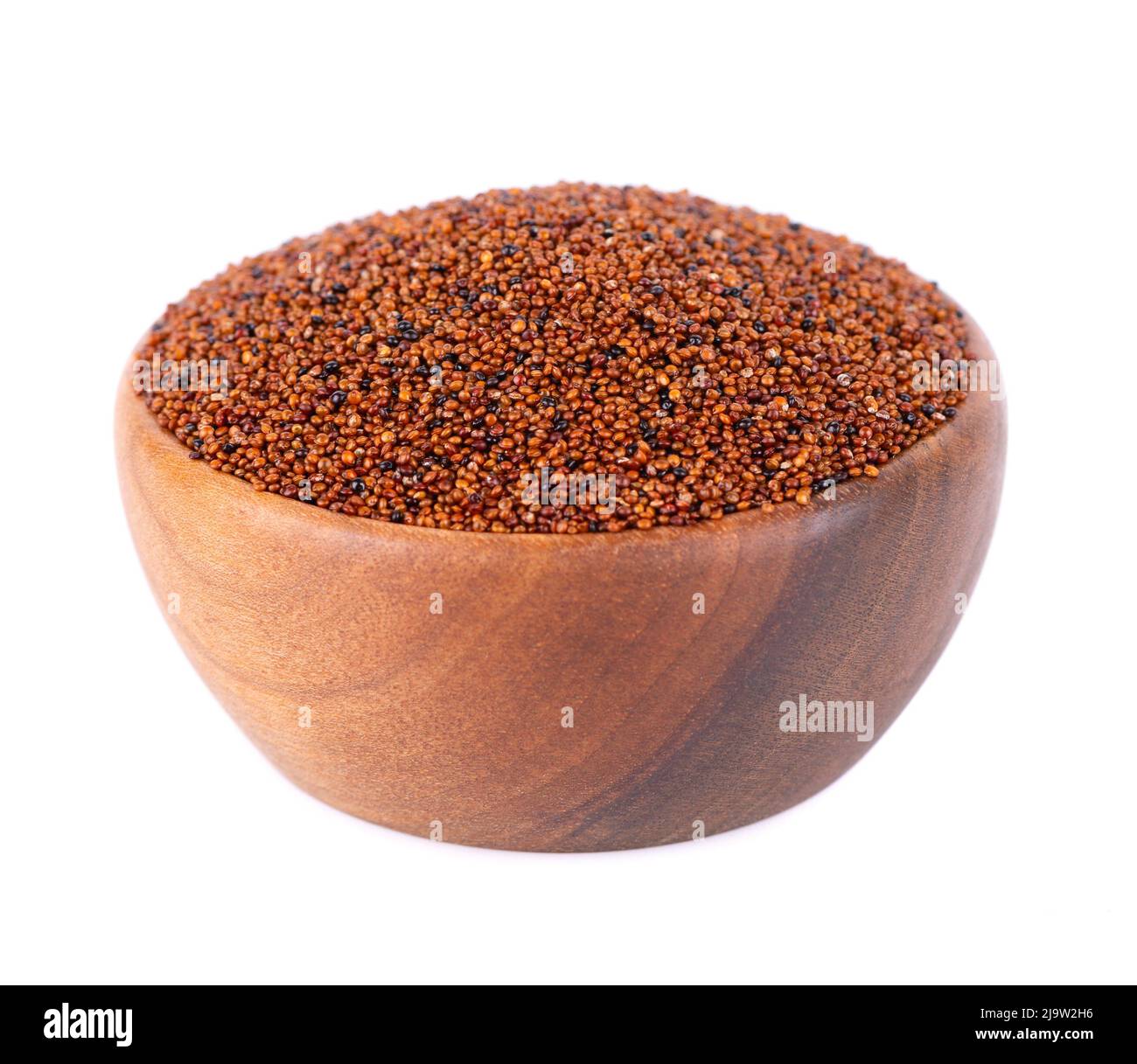 Canihua grains isolated on white background. Pile of qaniwa in wooden bowl. Dry grains of chenopodium pallidicaule Stock Photo