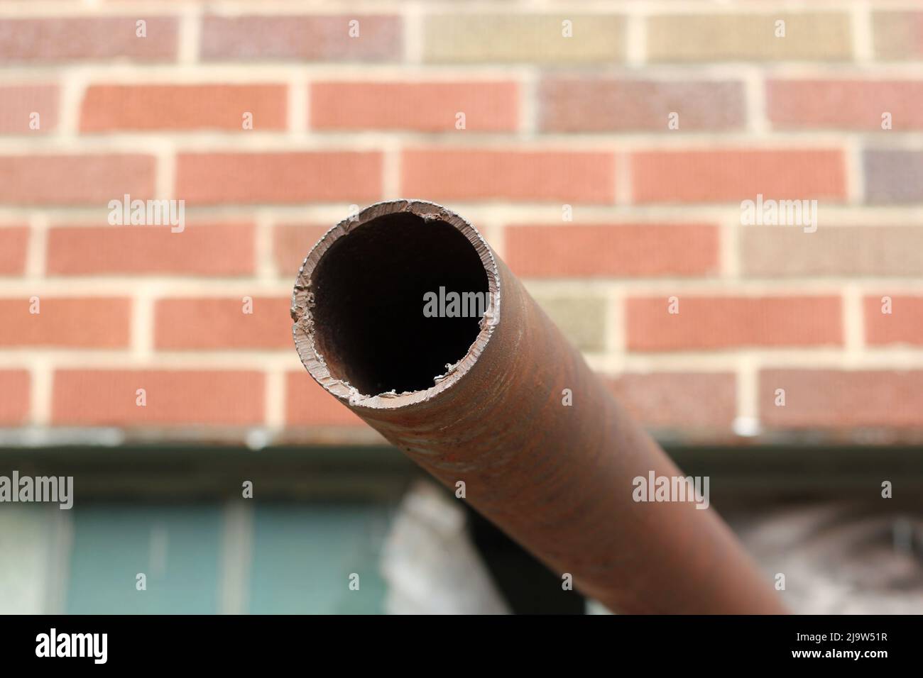 Old rusted pipe sticking out of the wall Stock Photo Alamy