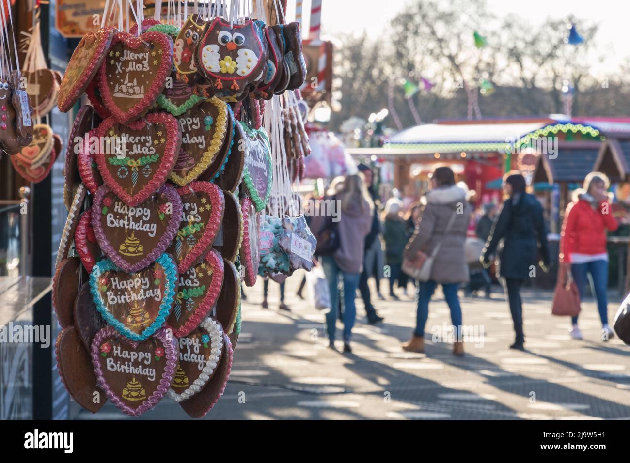 Gingerbread hearts on display at a confectionery stall of Christmas market in Hyde Park Winter Wonderland in London Stock Photo