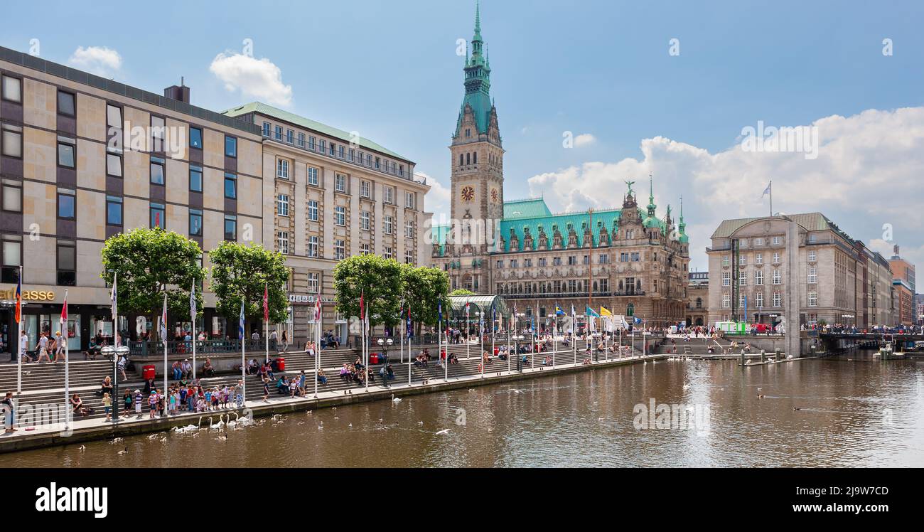Hamburg, Germany - July 12, 2011 : Waterfront along Alster Canal. Crowds enjoying the fine summer weather around the waterfront and Hamburg Town Hall. Stock Photo