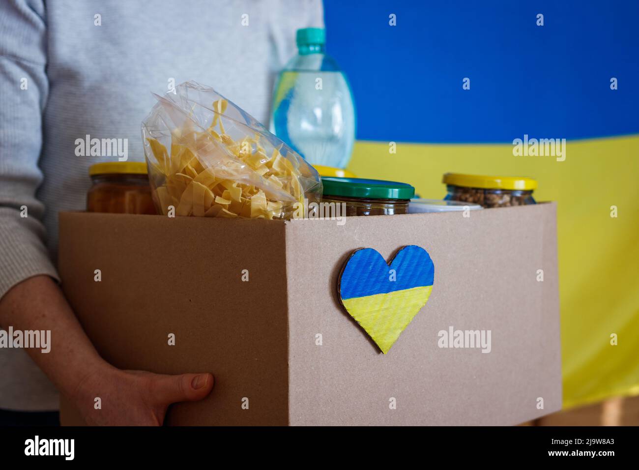 Humanitarian aid for Ukrainian refugees. Volunteer holding box with