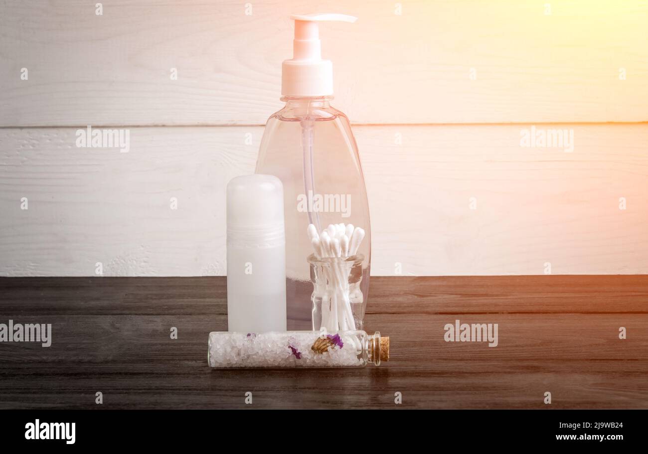 Spa beauty cosmetic products on white and black wooden background. Copyspace. Sun flare Stock Photo