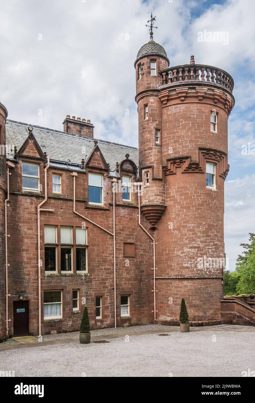 Threave House, a Scottish baronial mansion near Castle Douglas, is built in distinctive red sandstone & is  a National Trust for Scotland property. Stock Photo